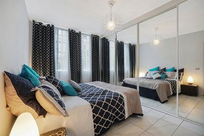 Mirrored Wardrobe Visually Doubles the Size of This Bedroom